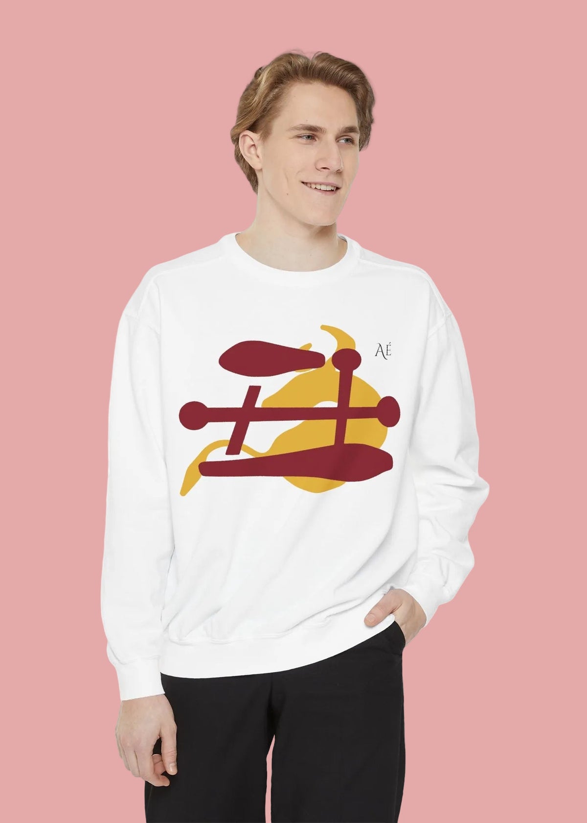 A man wearing a white crewneck sweatshirt with a graphic of Ox japanese zodiac sign, paired with blue jeans, against a plain white background.