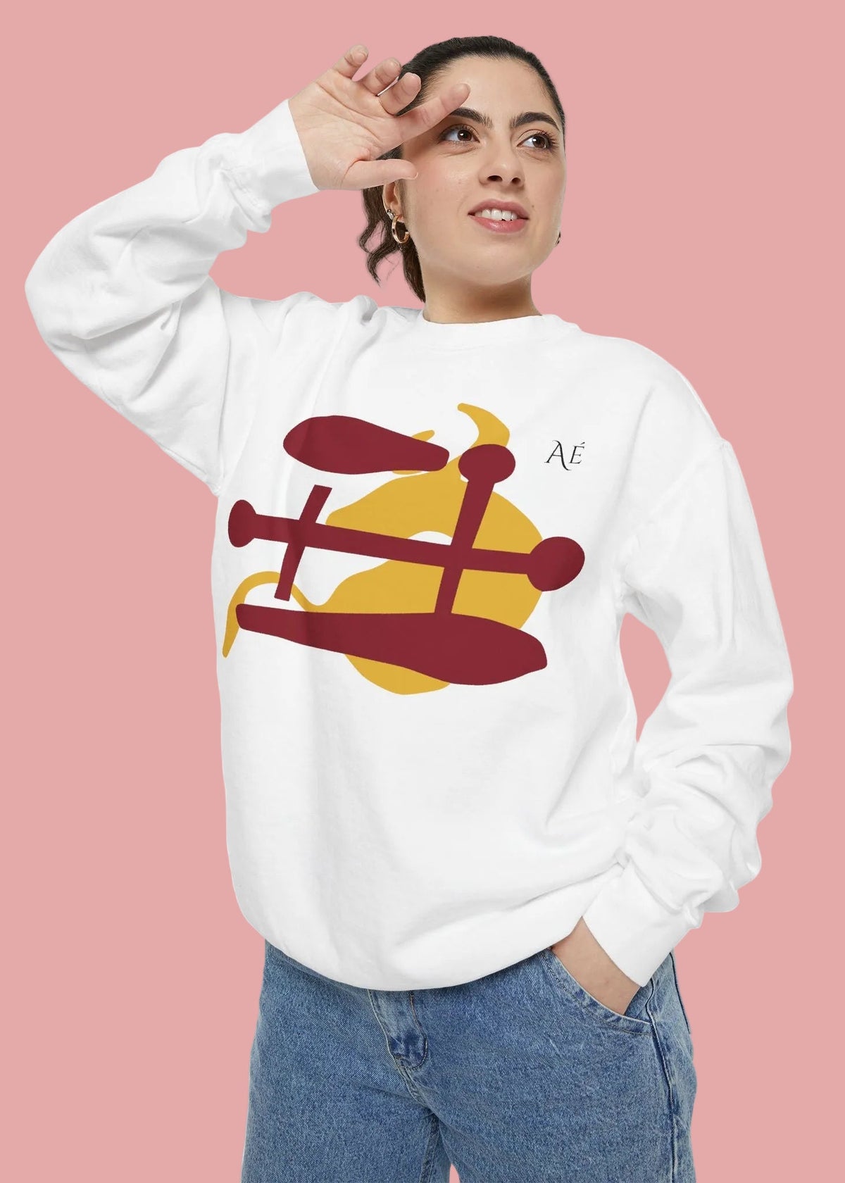 A woman wearing a white crewneck sweatshirt with a graphic of Ox japanese zodiac sign, paired with blue jeans, against a plain white background.