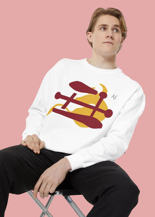 Person wearing a white sweatshirt with a Japanese zodiac Ox design, sitting on a chair against a white background